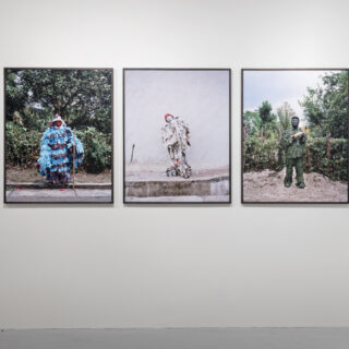 Three framed prints hung on a white wall