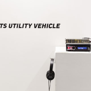 Soren Thilo Funder, Sport Utility Vehicle, 2010, modified car radio, cut vinyl wall text, digital audio, headphones, 10 min, from Crossing the Line: Contemporary Art from Denmark, Critical Distance Centre for Curators, 2016. Installation documentation by Toni Hafkenscheid.