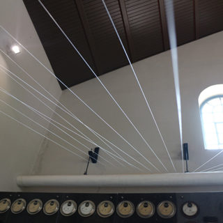 Syria… as my mother speaks (installation views), 2014. Nylon strings, contact mics, amp, computer, 24 x 30 feet. Site-specific installation at Textil Museum, Bocholt, Germany.