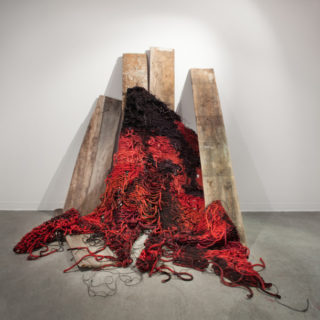 Cradling: In Ruins, 2014. Found barn wood, hand-dyed and burned sisal rope. 6’ x 3’ x 4’.