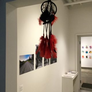 Starchild Dreaming Loud, Staying Connected 2, from Dreamcatcher series, wood, leather, beads and feathers, 2016;Sophia Nahz, Welcome, selections from a series of photographs, 2016, in Moving Home, curated by Amelia Merhar, Critical Distance Centre for Curators, 2017. Installation documentation by Shani K Parsons.
