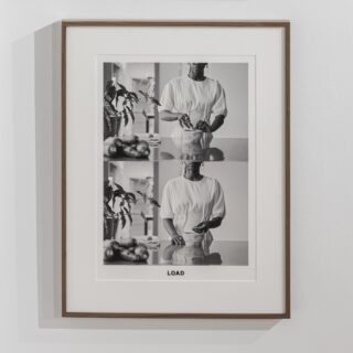 A framed black and white photographic diptych depicting a black woman holding processed cassava powder, captioned “LOAD” in bold black text.