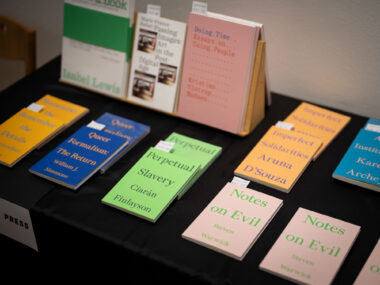 Various colourful books from Floating Opera Press are displayed on a table with black table cloth.