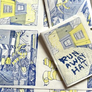 A blue and white, risograph printed, illustrated zine is shown folded and opened, titled RUN AWAY HAT.